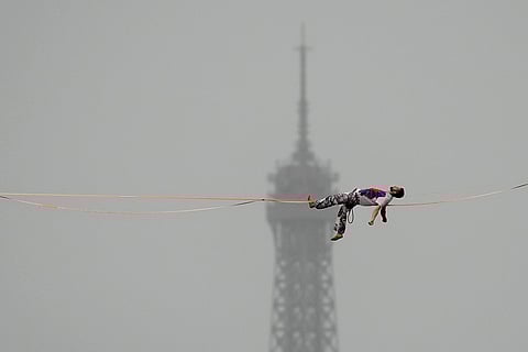 A tight rope walker performs during the opening ceremony